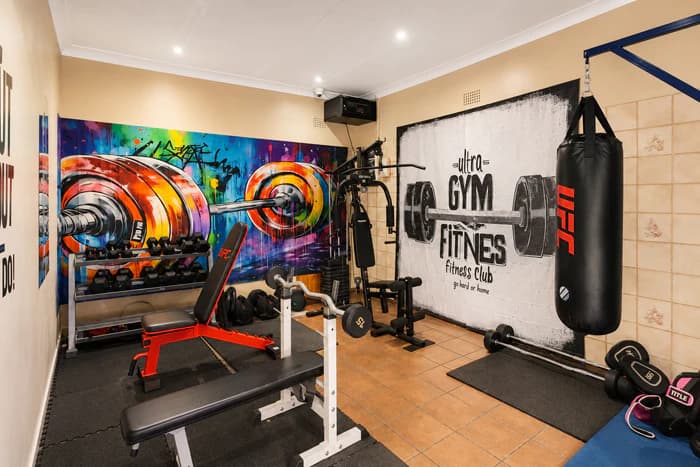 A clean Da Silva Academy activity space with exercise equipment and colourful wall artwork.